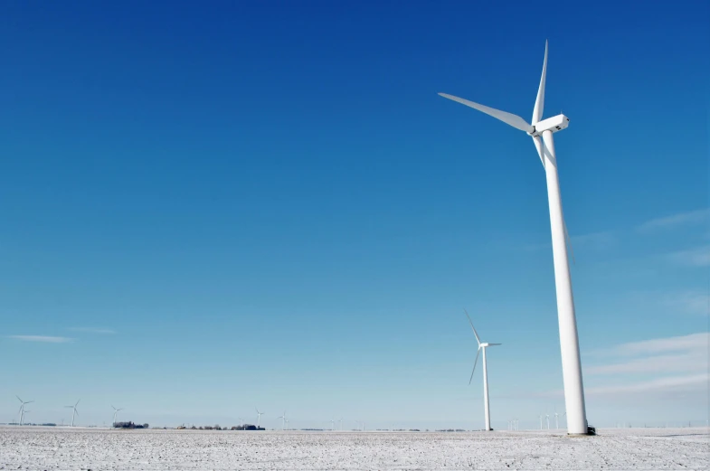 a group of wind turbines sitting on top of a snow covered field, blue clear skies, slide show, fan favorite, white