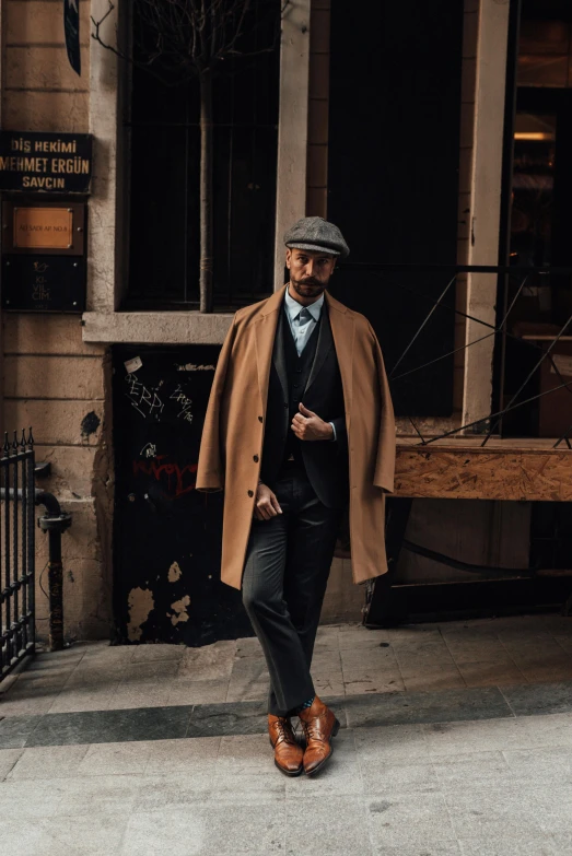 a man walking down a sidewalk in front of a building, inspired by Max Magnus Norman, reddit, peaky blinders gang, vintage clothing, caramel. rugged, thumbnail