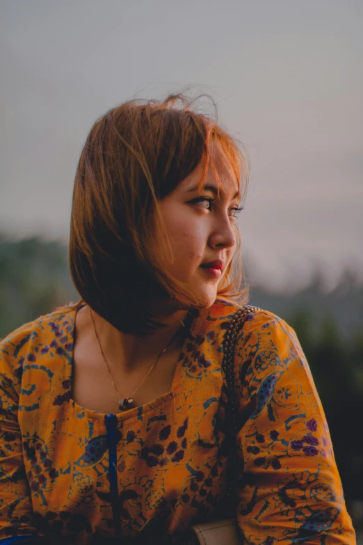a woman sitting on top of a wooden bench, inspired by Ruth Jên, pexels contest winner, realism, wearing yellow floral blouse, looking off into the distance, indonesia, ((portrait))