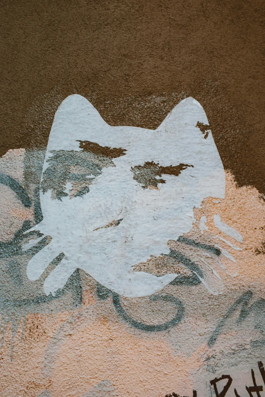 a painting of a cat on the side of a building, inspired by Antoni Tàpies, trending on unsplash, graffiti, covered in dust, high angle closeup portrait, rorschach, white outline