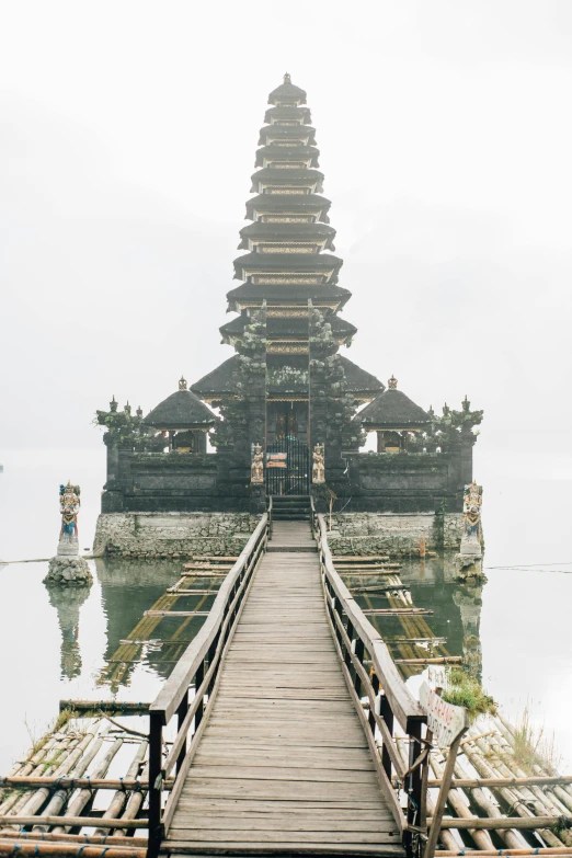 a bridge over a body of water with a pagoda in the background, by Daniel Lieske, unsplash, modernism, indonesia, multiple stories, undersea temple, 3/4 front view