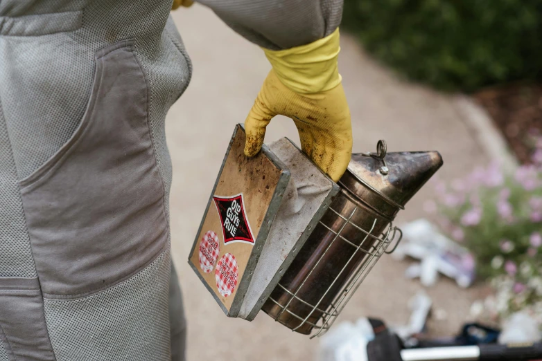 a person in yellow gloves holding a metal container, by Daniel Lieske, unsplash, happening, 🦩🪐🐞👩🏻🦳, burnt, pink, close-up product photo