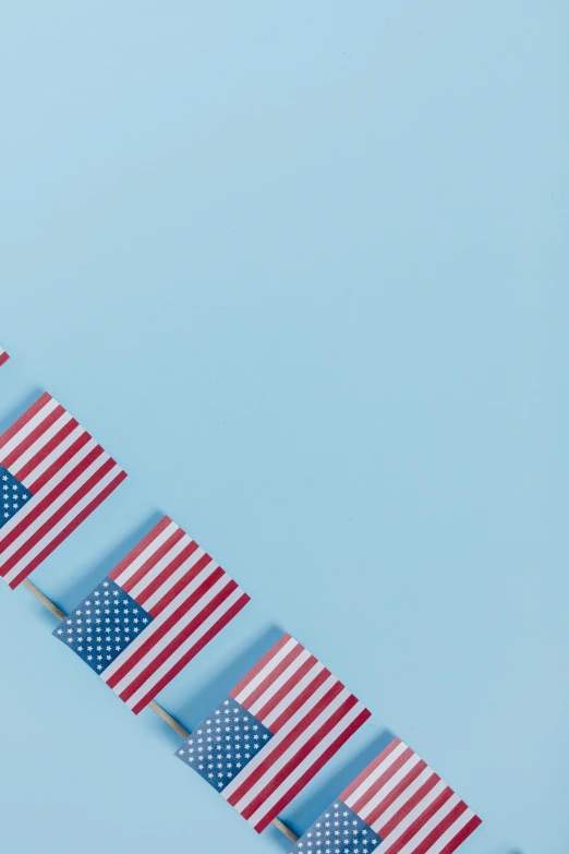 a row of american flags on a blue background, trending on unsplash, square, medical, presents, low quality photo