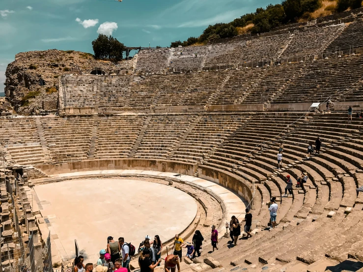 a group of people standing in the middle of an arena, pexels contest winner, renaissance, ancient mediterranean city, mini amphitheatre, large bubble archaeologies, touring