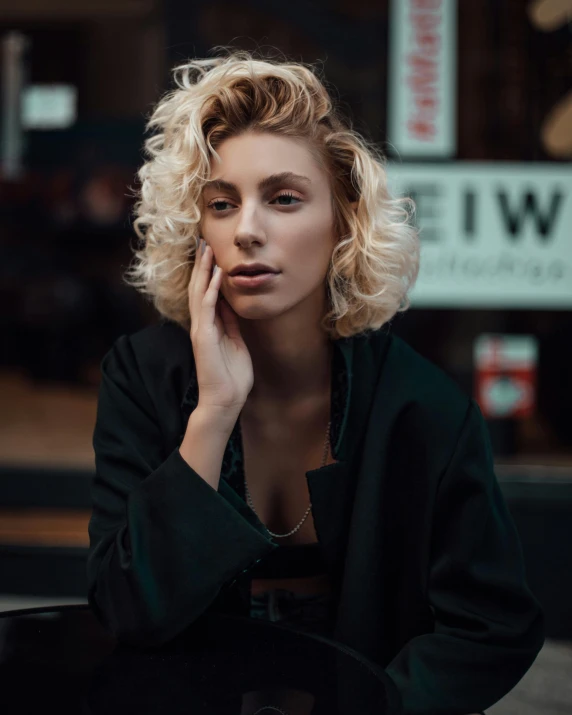 a woman sitting on a bench talking on a cell phone, a colorized photo, inspired by Elsa Bleda, trending on pexels, photorealism, short curly blonde haired girl, lovingly looking at camera, alessio albi, portrait of lady gaga