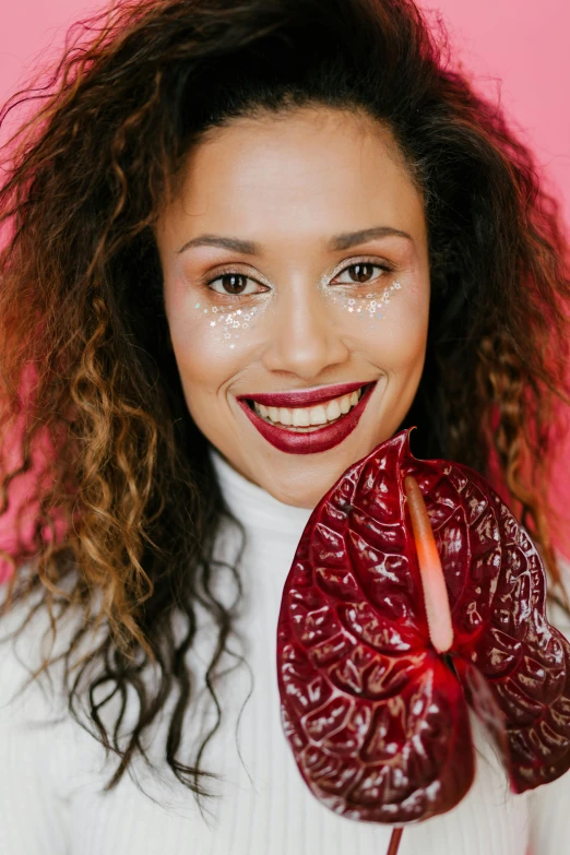 a woman holding a heart shaped lollipop in front of her face, an album cover, inspired by Aya Goda, trending on pexels, renaissance, mixed race woman, maroon red, lipgloss, detailed smile