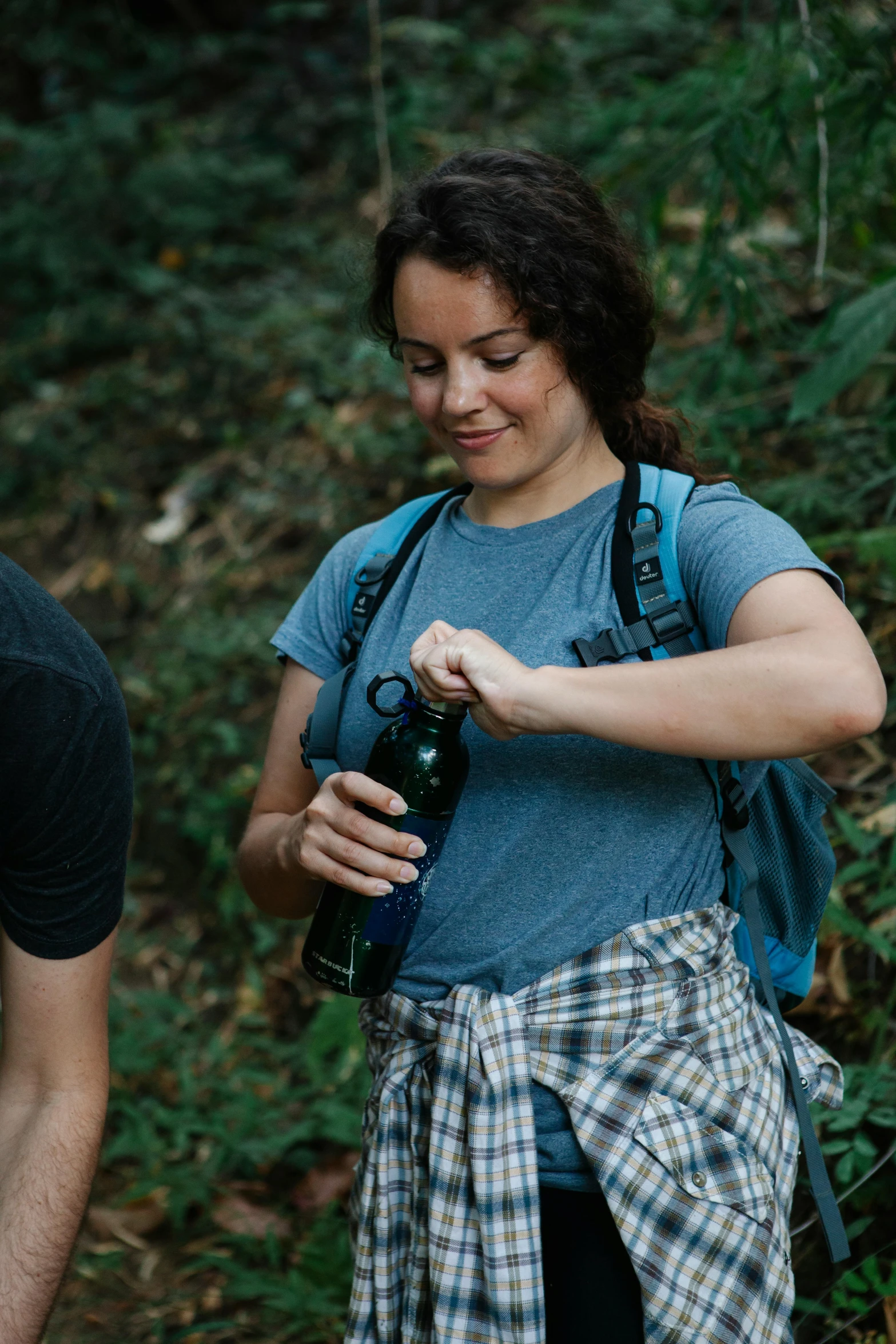 a man and a woman walking in the woods, pexels contest winner, holding a bottle of beer, hydration, avatar image, colombian