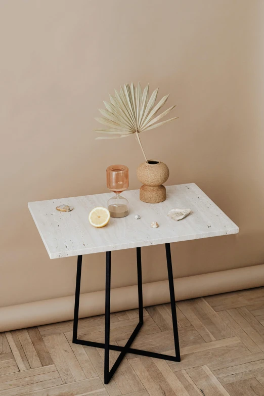 a white table sitting on top of a wooden floor, by Harvey Quaytman, unsplash, in a white boho style studio, ivory and black marble, miniature product photo, palms