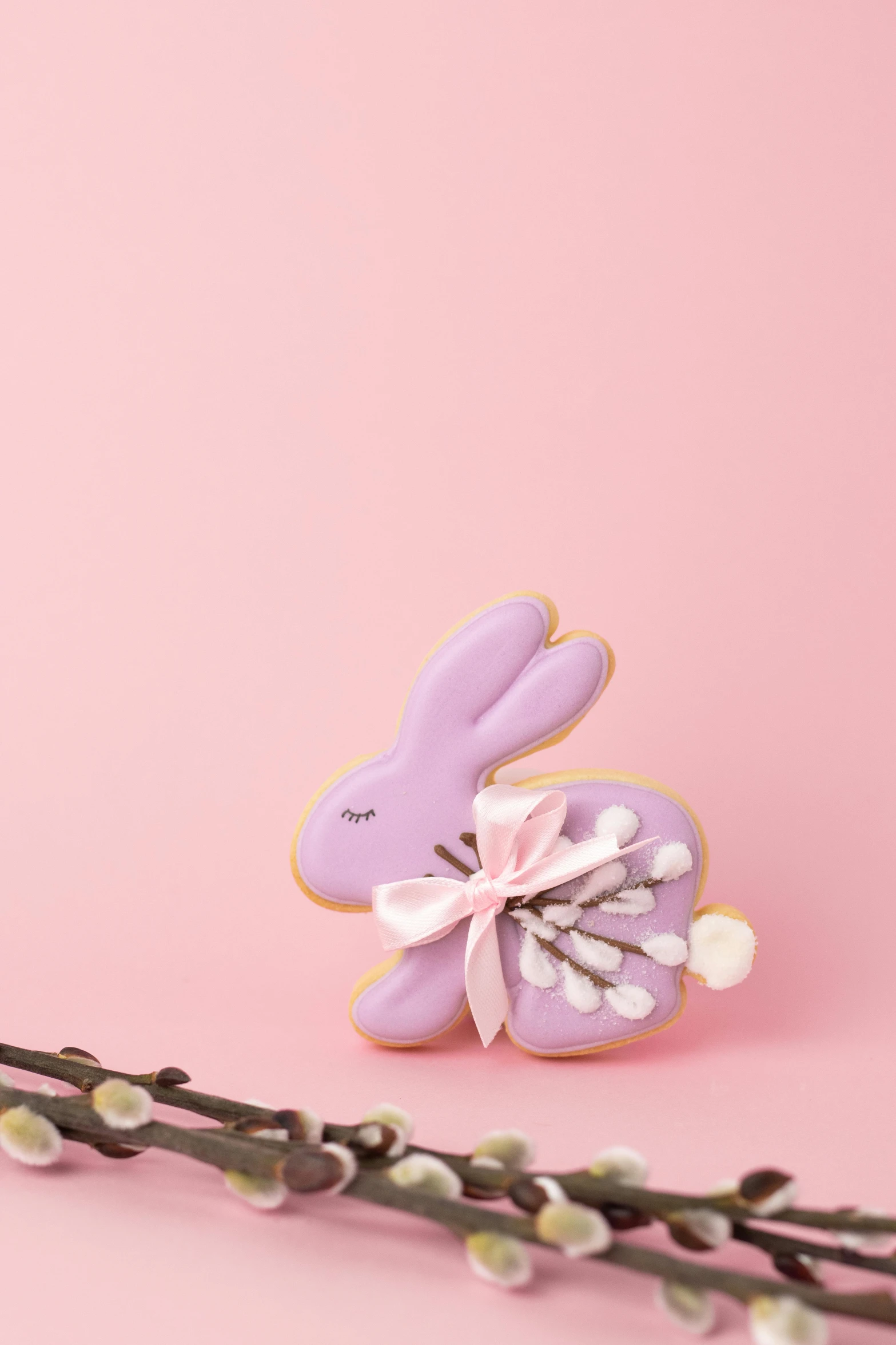 a purple bunny sitting on top of a branch of willow, a pastel, inspired by Eva Gonzalès, cookies, close-up product photo, detailed product image, sleek hands
