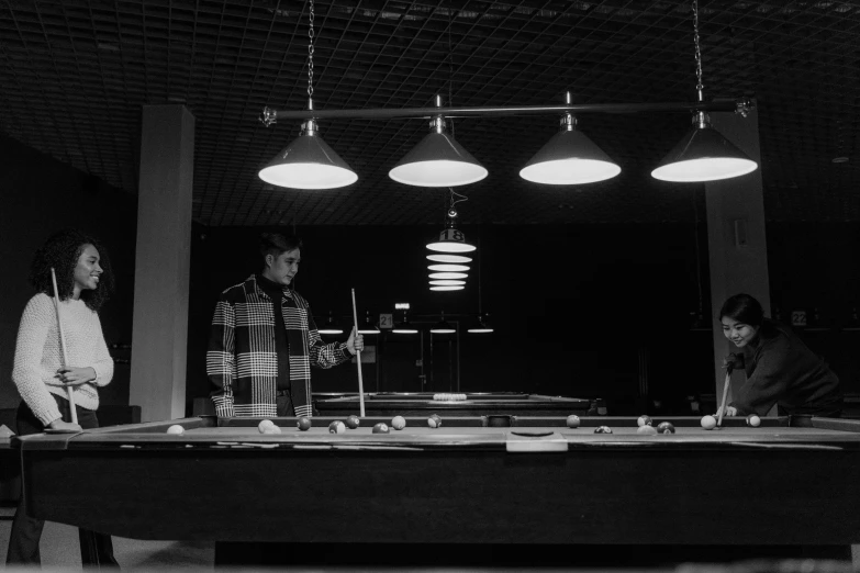 a group of people standing around a pool table, a black and white photo, unsplash, purism, man in futurist 6 0 ´ s lab, minimalist cinematic lighting, cinematic outfit photo, gif