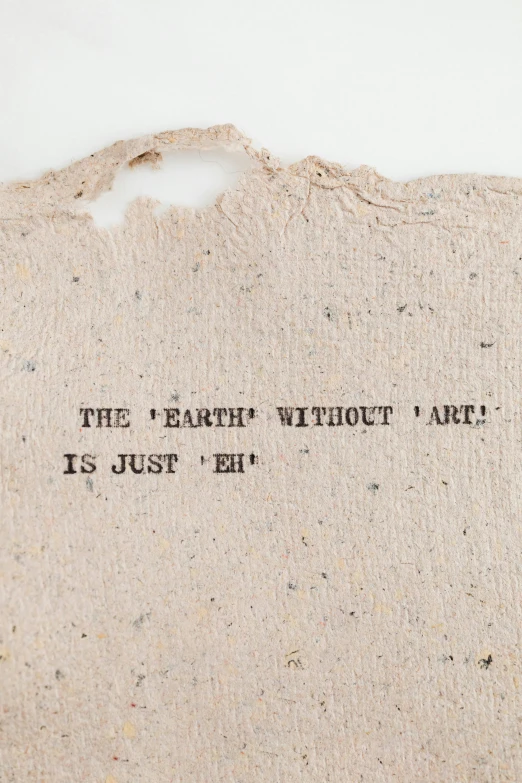 a piece of fabric with the words the earth without art is just left, an album cover, by Joseph Beuys, unsplash, environmental art, detailed product image, concrete poetry, background image, on high-quality paper