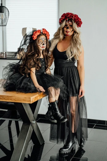 a couple of women standing next to each other, halloween decorations, profile image, black outfit, daughter