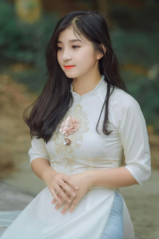 a woman sitting on the ground in a white dress, inspired by Dai Xi, pexels contest winner, realism, wearing a cute top, ao dai, headshot, square