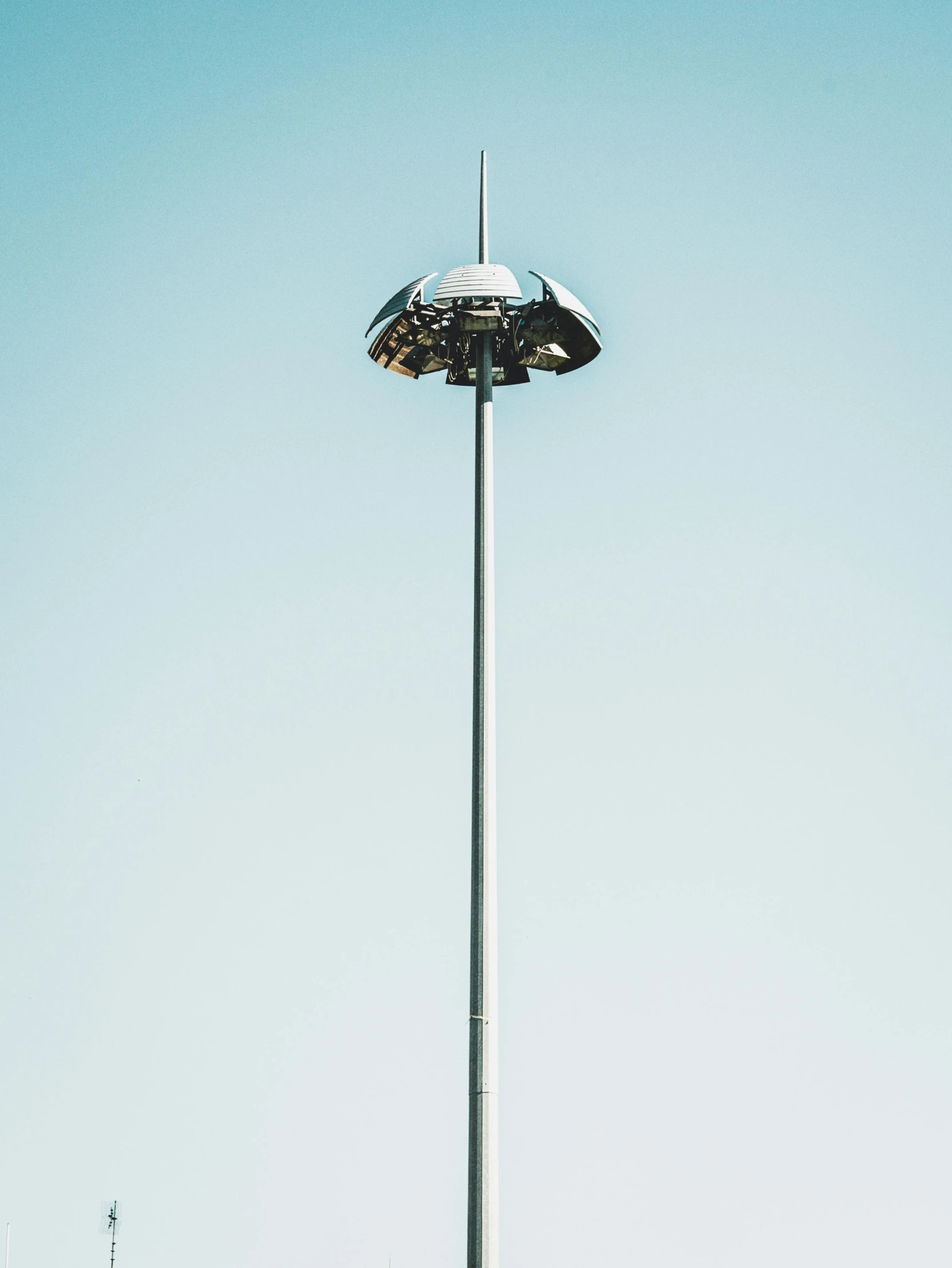 a tall pole with a light on top of it, poster art, unsplash contest winner, postminimalism, stadium landscape, symmetrical rim light, clear skies, volumetric search lights