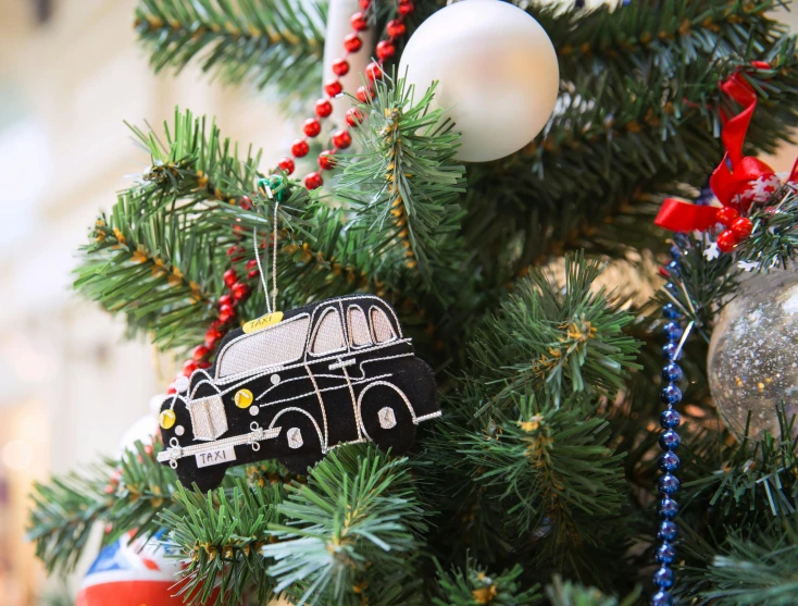 a close up of a christmas tree with ornaments, by Julia Pishtar, pexels, folk art, black car, square, taxi, hyper detailed ornament