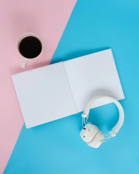 a book, headphones and a cup of coffee on a blue and pink background, happening, on white paper, high res photograph, product image, no text