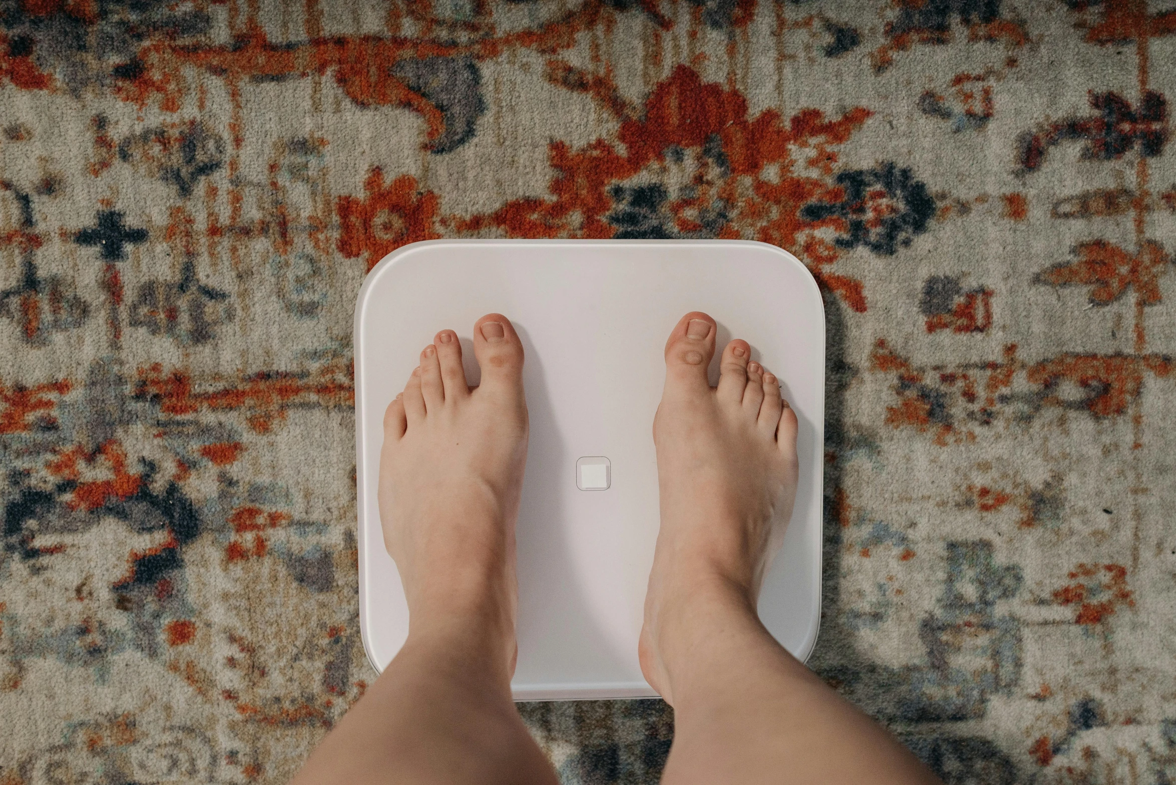 a person standing on top of a bathroom scale, by Carey Morris, pexels contest winner, square, 15081959 21121991 01012000 4k, on a coffee table, medium poly