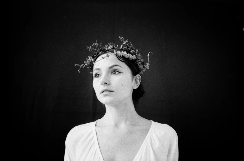 a black and white photo of a woman wearing a crown, by Adam Marczyński, flowers in her dark hair, medium format, vintage film stock, twigs