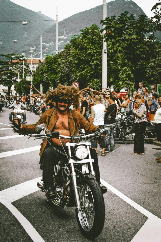 a man riding on the back of a motorcycle down a street, pexels contest winner, renaissance, chest hair, pride parade, hair made of trees, rio de janeiro