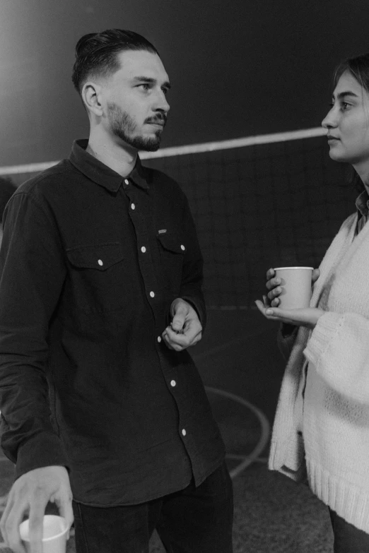 a man and a woman standing next to each other, a black and white photo, pexels contest winner, antipodeans, volleyball, drinking a coffee, demna gvasalia, holding court