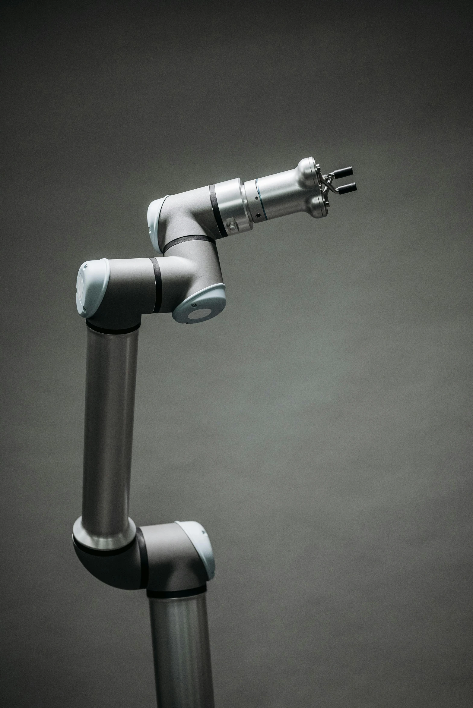 a close up of a metal object on a black background, a digital rendering, inspired by Robert Zünd, unsplash, robotic arms, on a gray background, healthcare, pipe