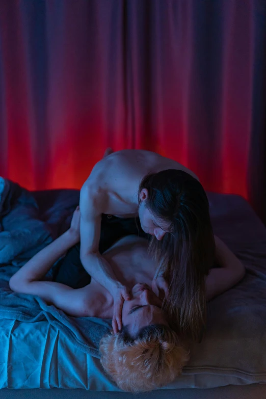 a man and woman laying in bed next to each other, inspired by Nan Goldin, unsplash contest winner, romanticism, blue and red lights, man grabbing a womans waist, barely lit warm violet red light, behind red curtains