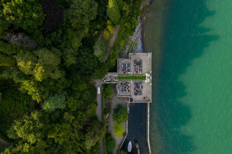 a large body of water next to a forest, an album cover, by Jan Rustem, pexels contest winner, an aerial tennis court, near a jetty, swiss architecture, group photo