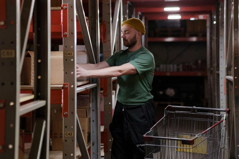 a man pushing a shopping cart through a warehouse, a portrait, pexels, avatar image, maintenance photo, thumbnail, bearded and built