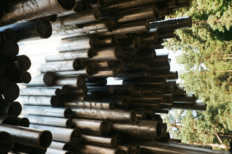 a bunch of pipes stacked on top of each other, by Cornelia Parker, unsplash, kinetic art, in a metal forest, part of the screen, ilustration, pipe organ