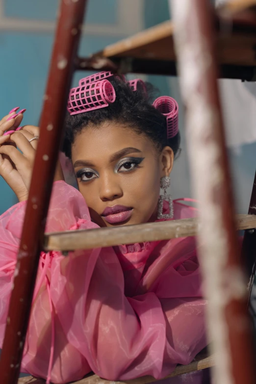 a woman in a pink dress leaning on a ladder, an album cover, inspired by Chinwe Chukwuogo-Roy, trending on pexels, renaissance, sitting in a plastic throne, aggressive look, still from a music video, close-up shoot