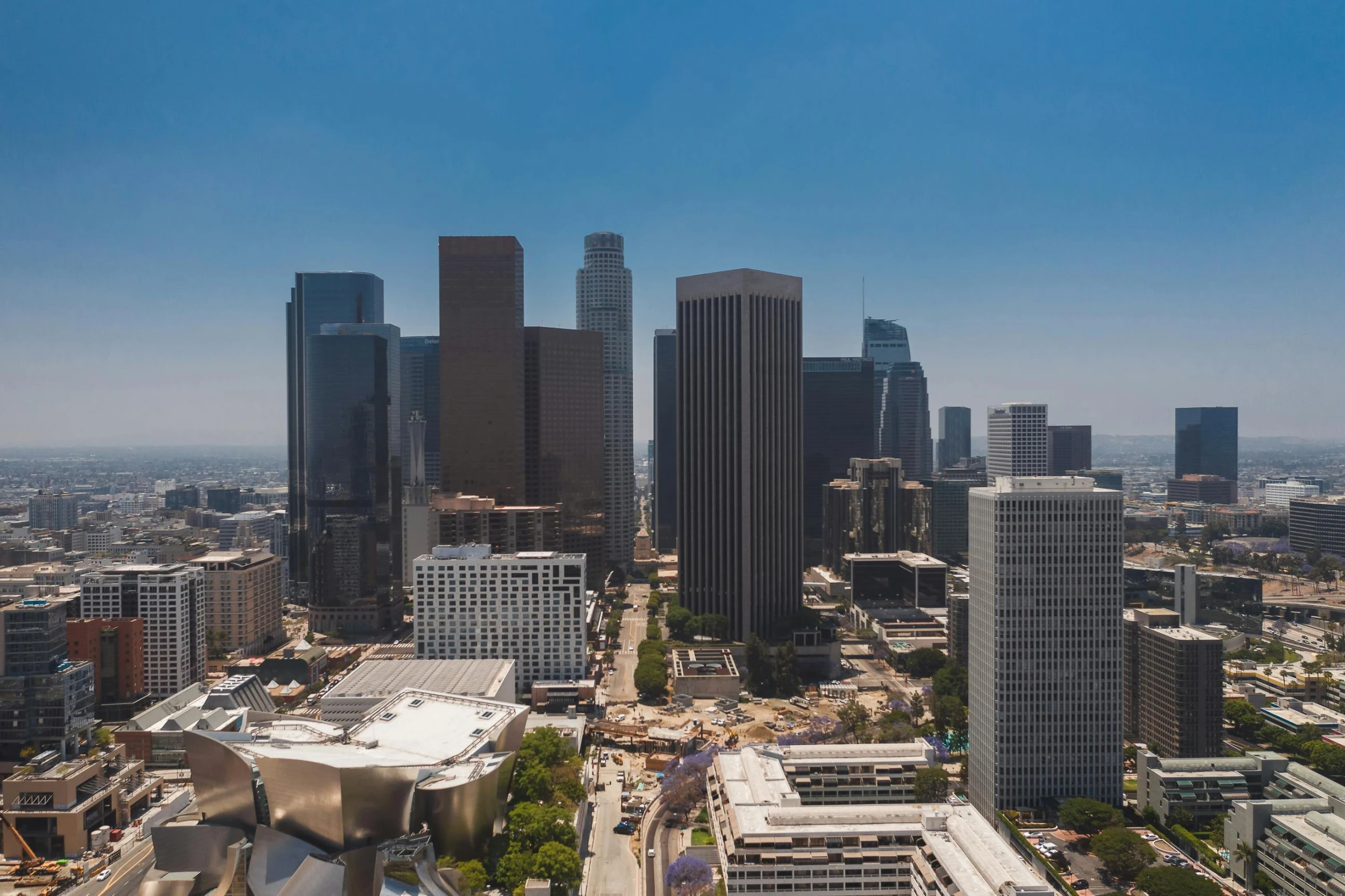 an aerial view of a city with tall buildings, inspired by L. A. Ring, unsplash contest winner, hyperrealism, morphosis, skyline view from a rooftop, frank gehry architecture, hollywood promotional image