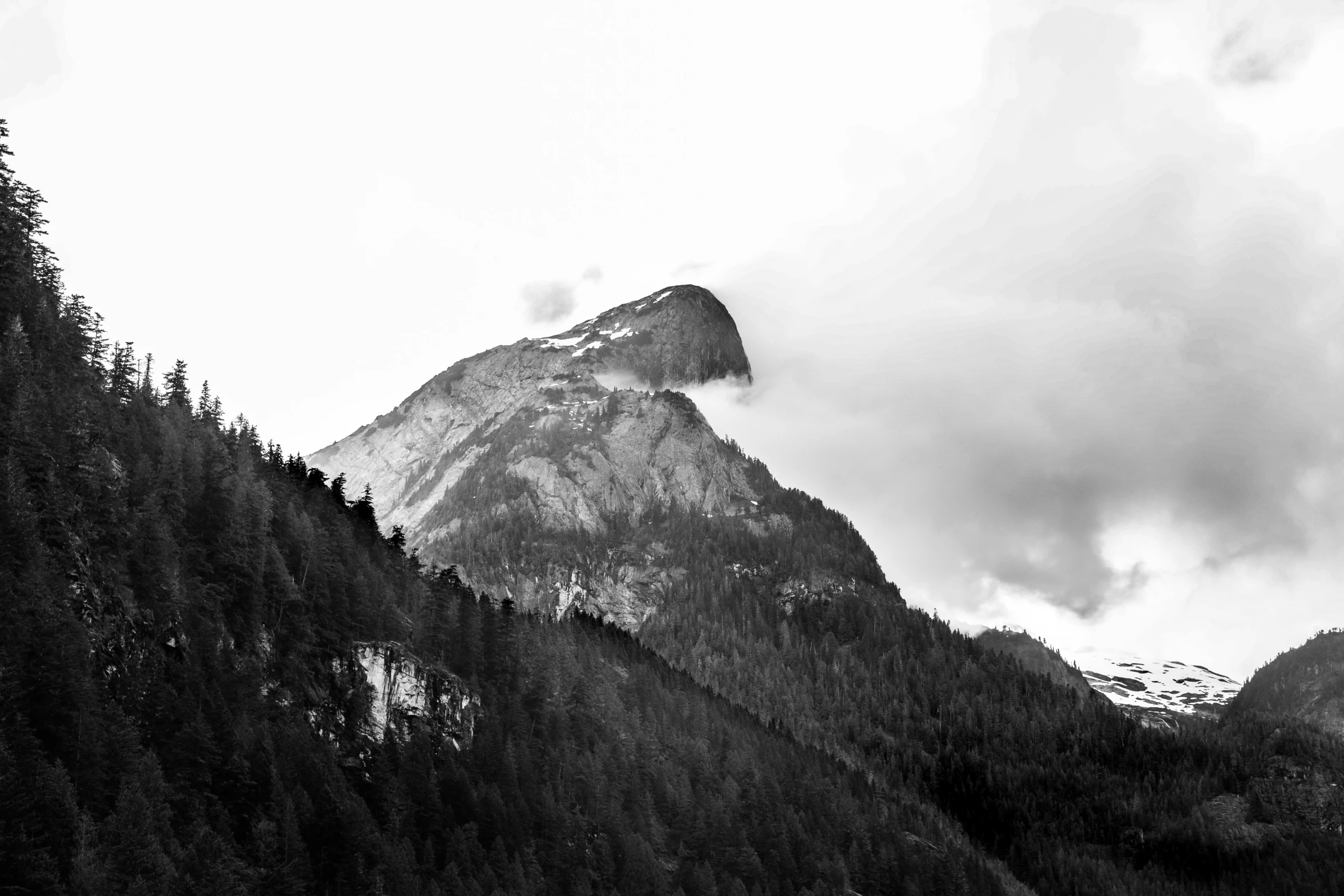 a black and white photo of a mountain, a black and white photo, by Karl Walser, unsplash, high quality upload, giant imposing mountain, a wooden, recognizable