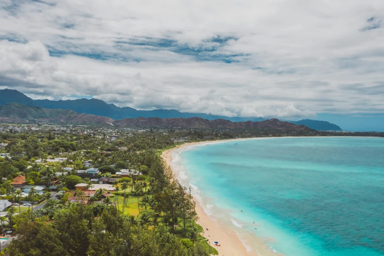 a beach that is next to a body of water, by Drew Tucker, unsplash contest winner, hurufiyya, hawaii, hills and ocean, wide high angle view, festivals