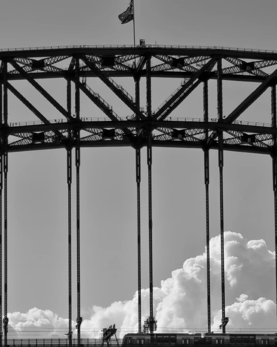 a black and white photo of a bridge, a black and white photo, inspired by Alfred Eisenstaedt, unsplash, surrealism, giant clouds, hoog detail, detailed silhouette, hell gate