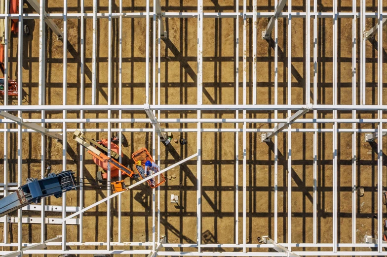 a group of construction workers working on a building, a portrait, by Lee Loughridge, unsplash, constructivism, top - down view, cages, full colour, square lines