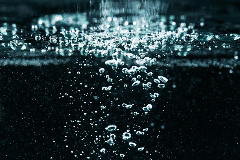 a close up of a water surface with bubbles, inspired by Elsa Bleda, unsplash, conceptual art, dark glowing rain, instagram post, hyperrealistic octane render, low - angle shot