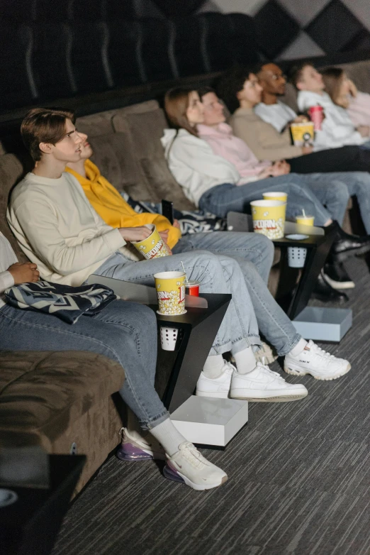 a group of people sitting in a movie theater, sydney sweeney, slide show, non-binary, [ theatrical ]