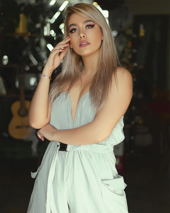 a woman in a white dress smoking a cigarette, by Robbie Trevino, long straight silver hair, cindy avelino, lovingly looking at camera, low quality photo