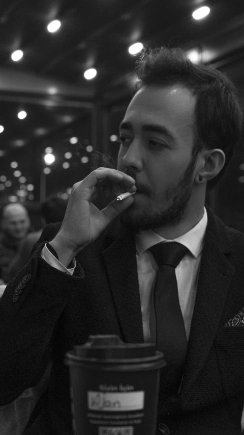 a black and white photo of a man eating a donut, inspired by William Grant Stevenson, reddit, hyperrealism, cigars, discord profile picture, man in black suit, profile image