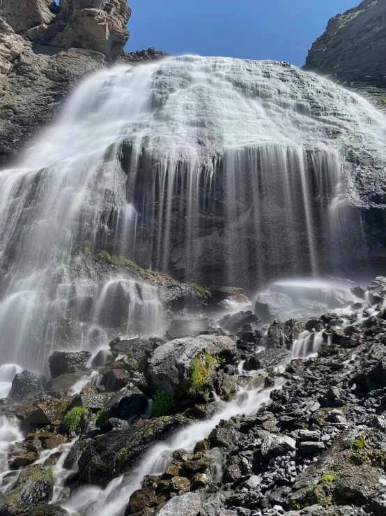 a man standing in front of a waterfall, an album cover, inspired by Johan Christian Dahl, hurufiyya, up close picture, thumbnail, ellora, hestiasula head