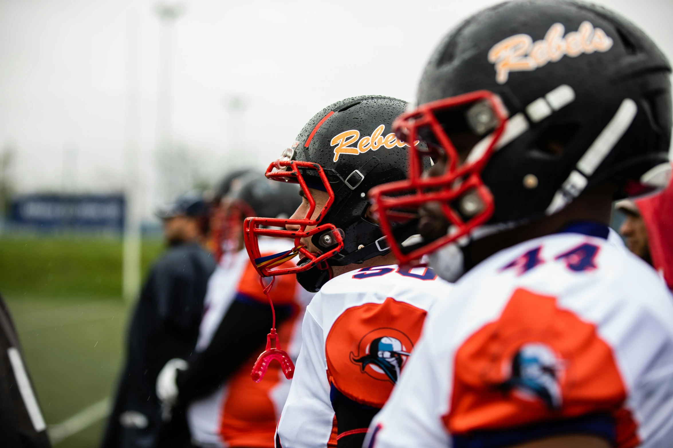 a group of young men standing next to each other on a field, by Raphaël Collin, reddit, helmet view, professional sports style, profile image, close-up photo