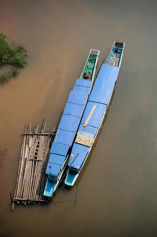 a couple of boats floating on top of a river, by Jan Tengnagel, sumatraism, slide show, close-up from above, cambodia, docks