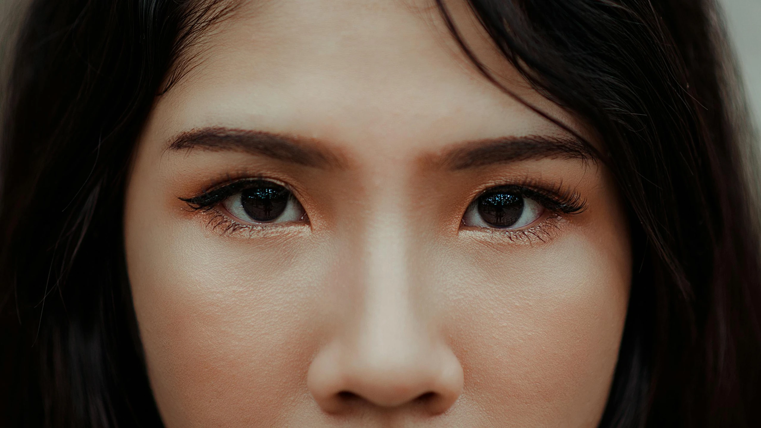 a close up of a woman with long hair, trending on pexels, hyperrealism, korean symmetrical face, scar under left eye, professional closeup photo, south east asian with round face