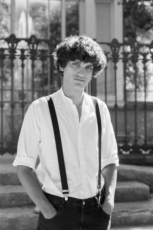 a black and white photo of a man in suspenders, an album cover, inspired by August Sander, renaissance, curly bangs, riccardo scamarcio, ƒ/5.6, summertime