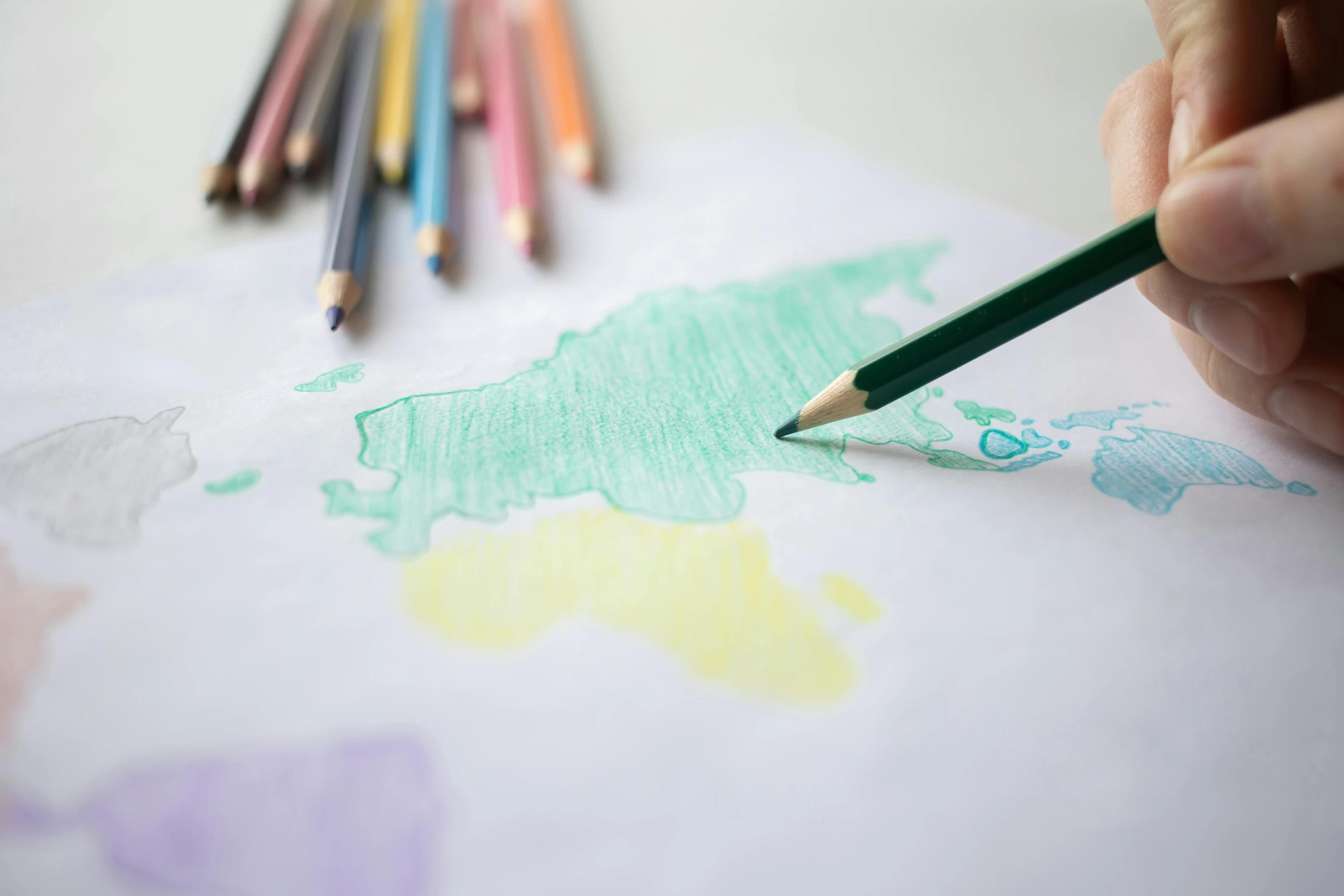 a person drawing a map with colored pencils, a child's drawing, by karolis strautniekas, pexels contest winner, crayon art, several continents, colouring page, multiple stories, & all the world around you