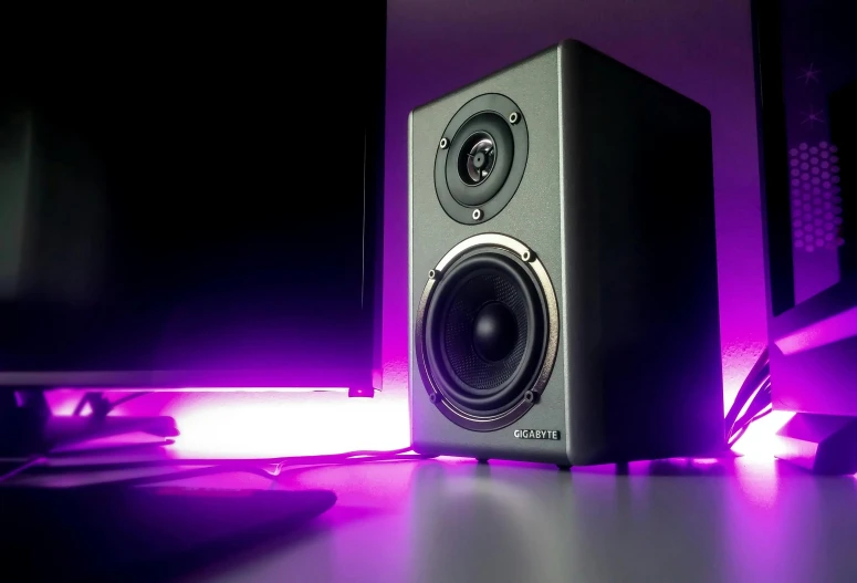 a pair of speakers sitting on top of a desk, pexels, computer art, purple accent lighting, cinematic counter light, glowing with silver light, dioaxizine purple