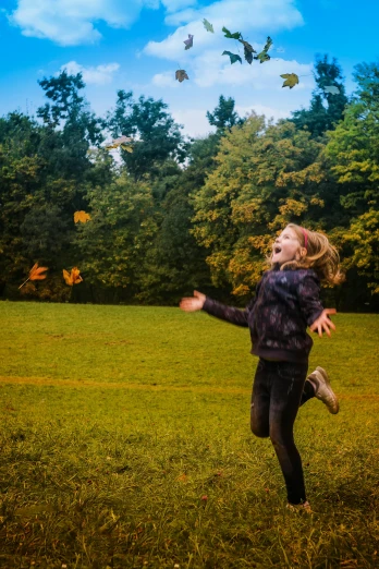 a little girl standing on top of a lush green field, a picture, pexels contest winner, falling leaves, screaming into air, at a park, 15081959 21121991 01012000 4k