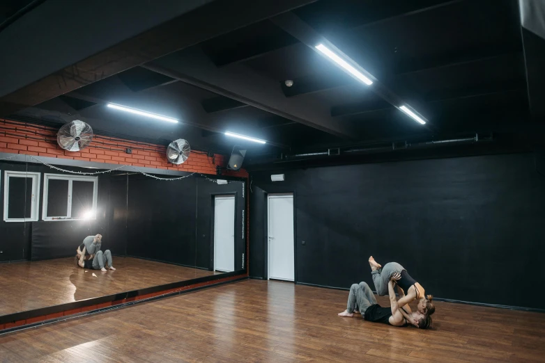 two people sitting on the floor in front of a mirror, by Emma Andijewska, hurufiyya, neo kyiv, dancefloor, profile image, large open room