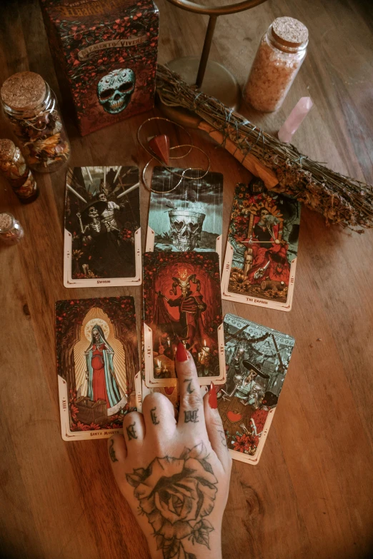 a person holding a deck of cards on a table, maximalism, witches, fairycore, ilustration, old-fashioned tarot card