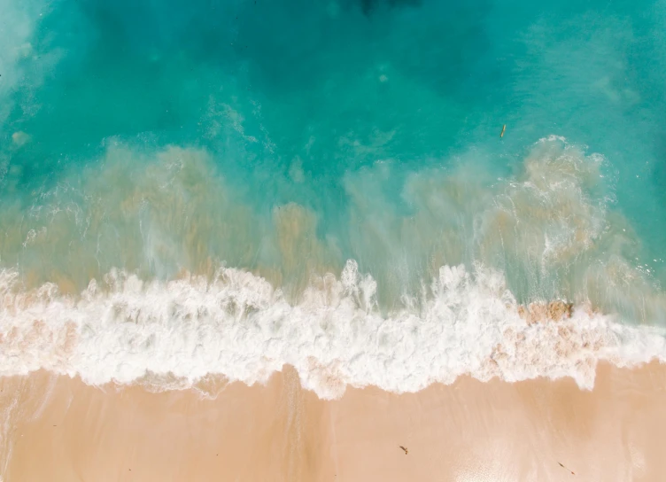 a person riding a surfboard on top of a sandy beach, pexels contest winner, minimalism, turquoise ocean, drone footage, thumbnail, 1 2 9 7